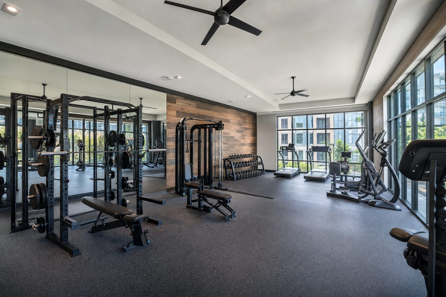 New community fitness center with strength equipment and large windows