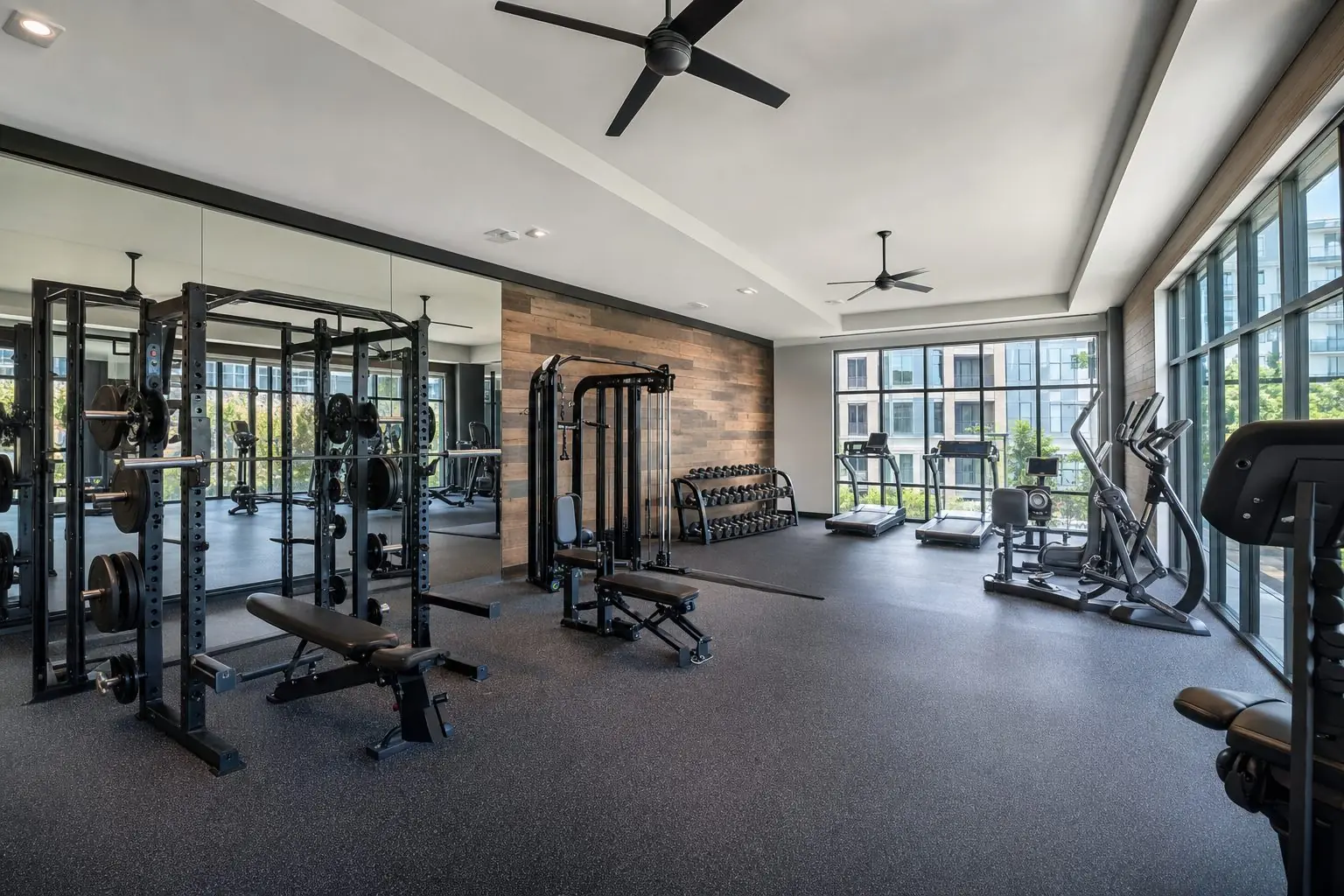New community fitness center with strength equipment and large windows